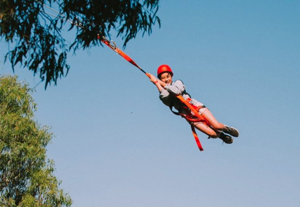 Picture of young girl on giant swing at family gathering and large family camp accommodation near Melbourne.