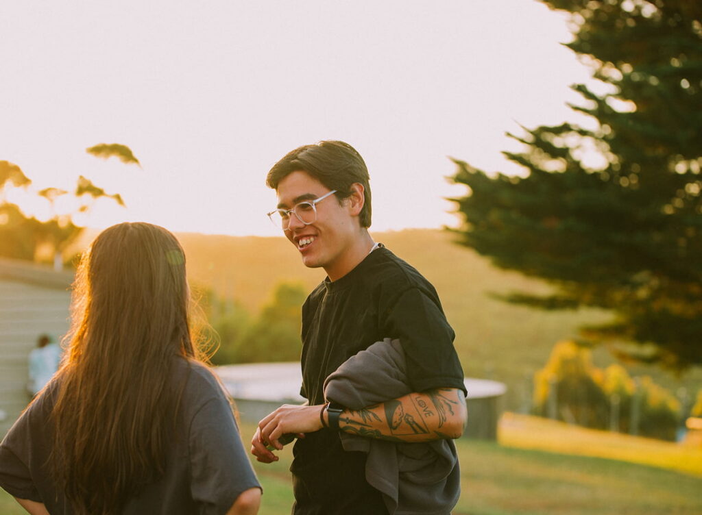 Image of girl and boy talking looking over the valleys at large group retreat near Melbourne.